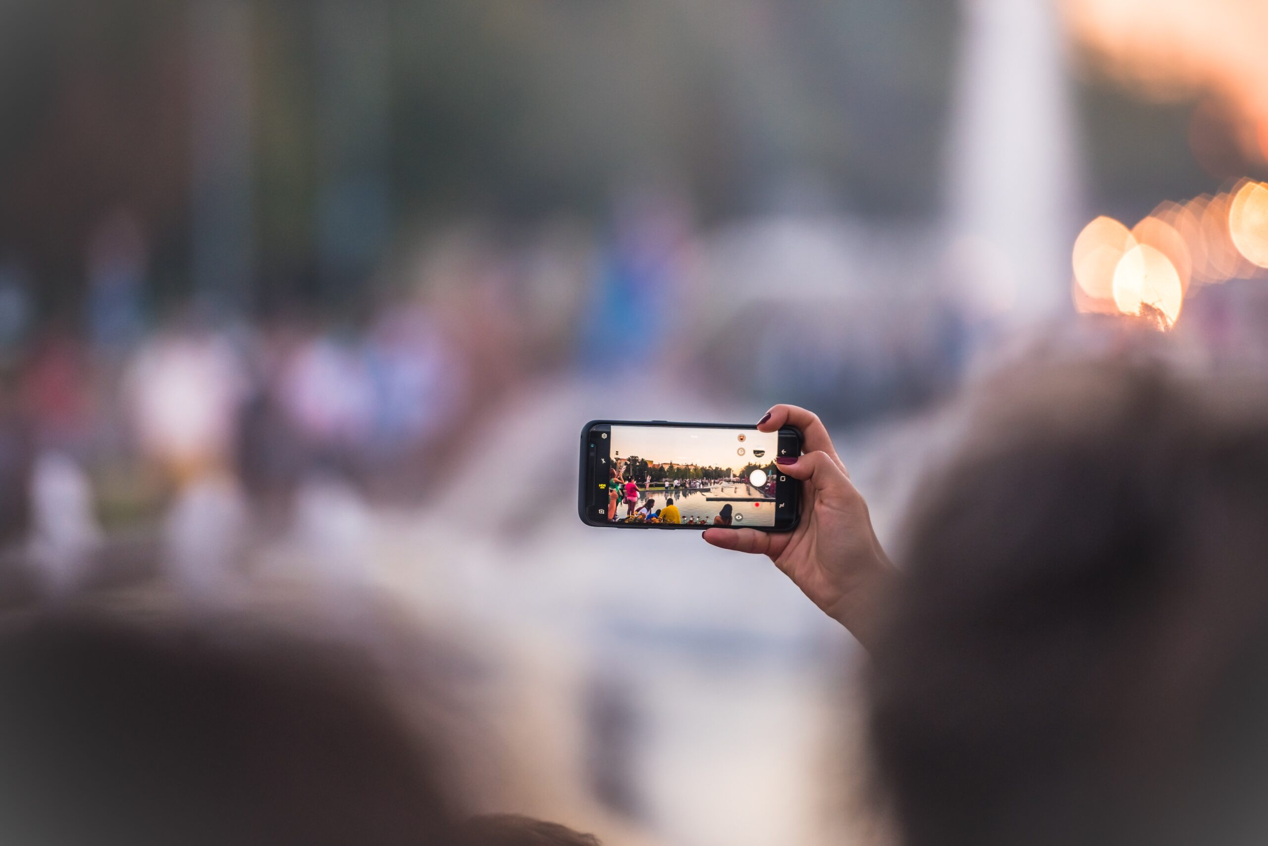 Image of a person taking a photo on their mobile phone