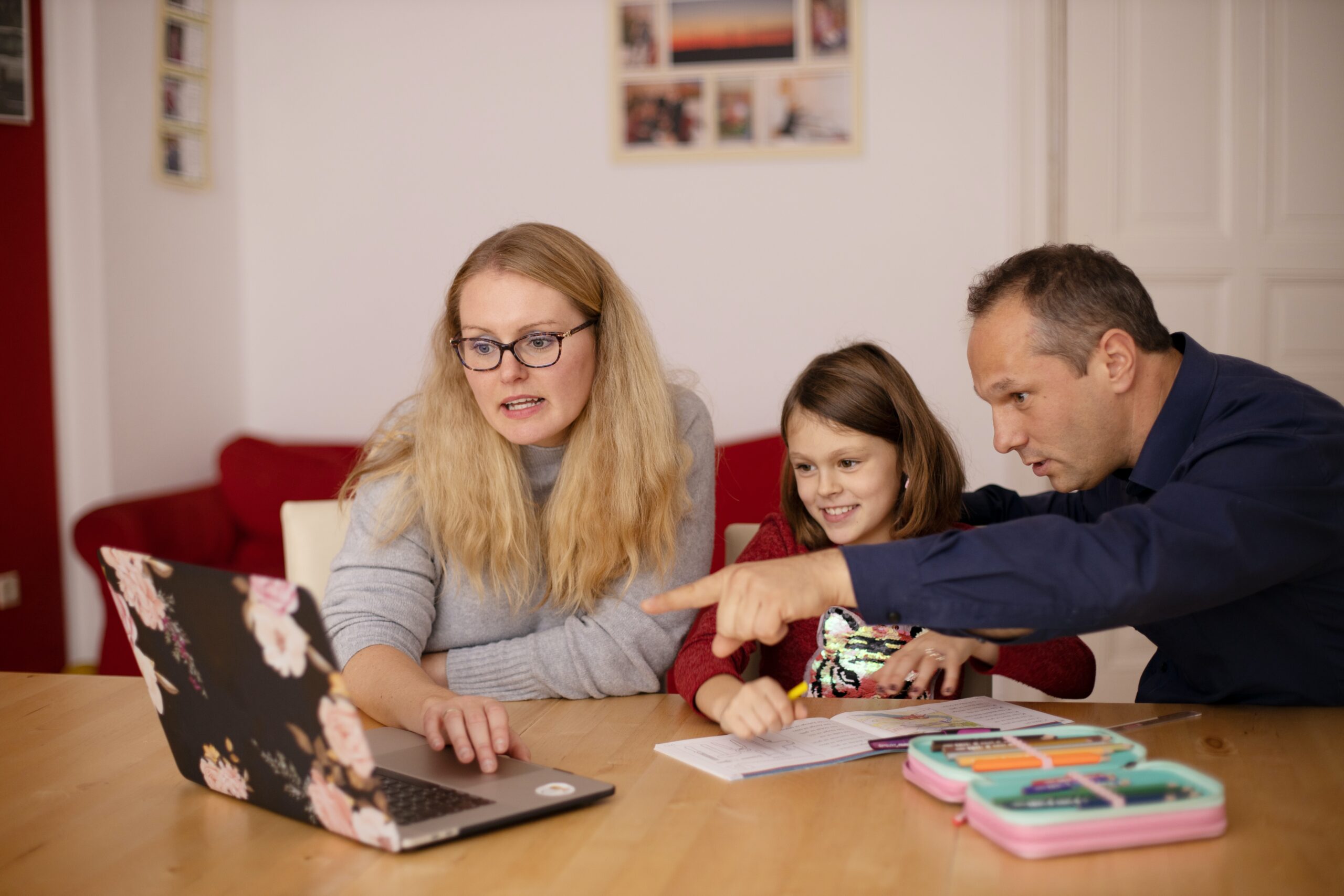 Image of a two parents and a child looking at a laptop
